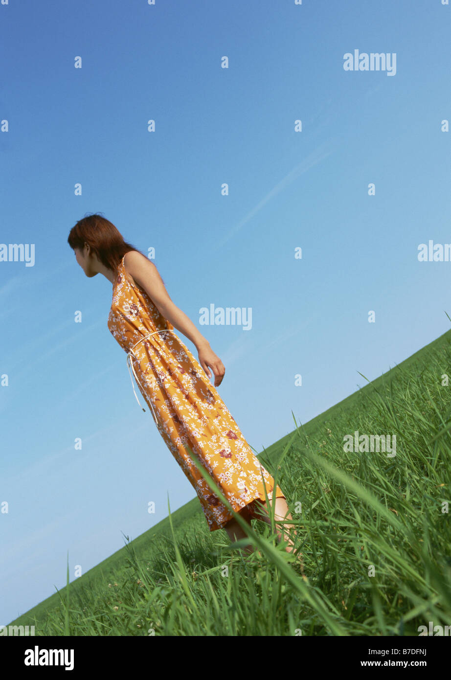 Woman standing in field Stock Photo - Alamy