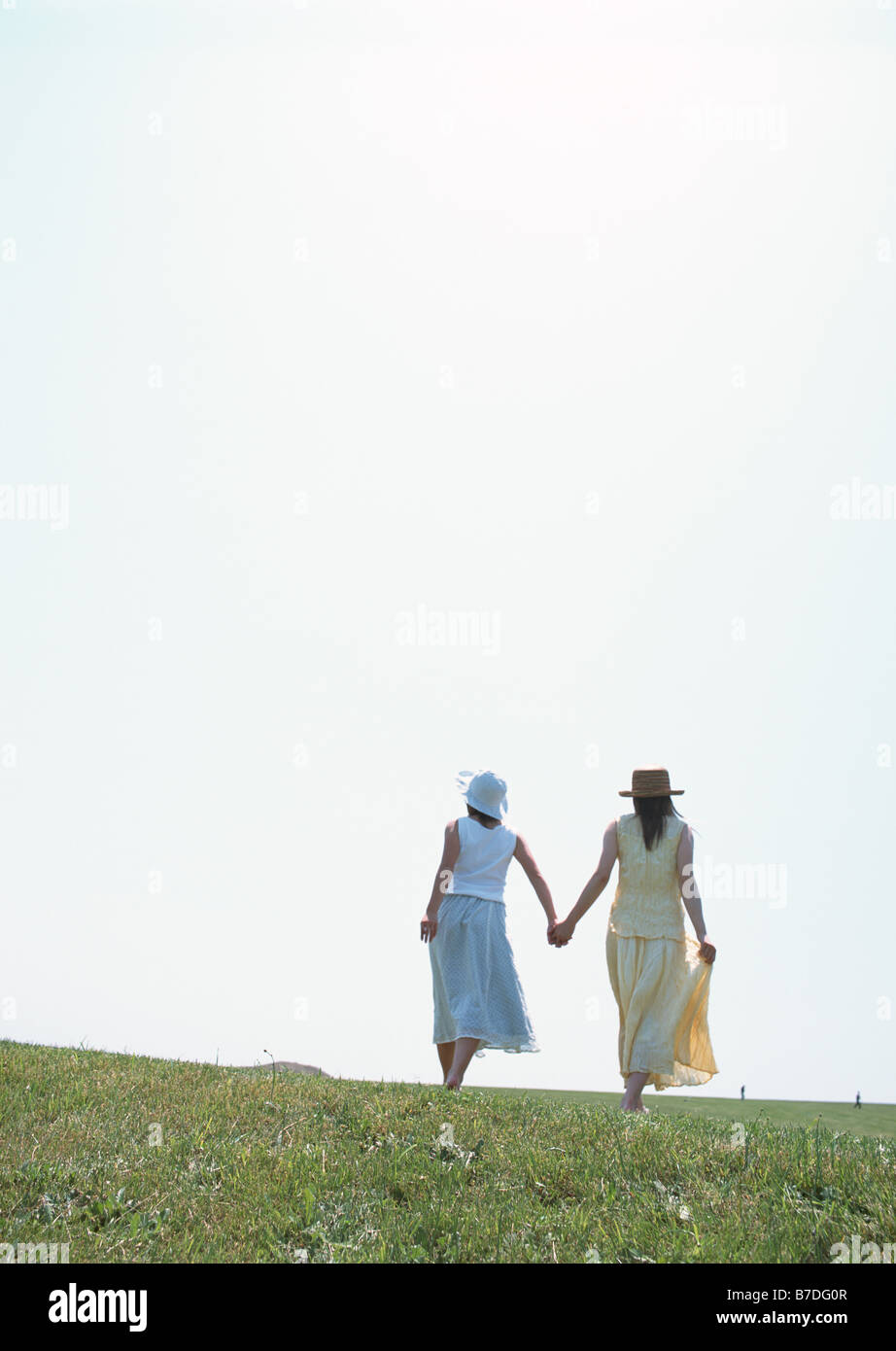 Women walking hand in hand Stock Photo - Alamy