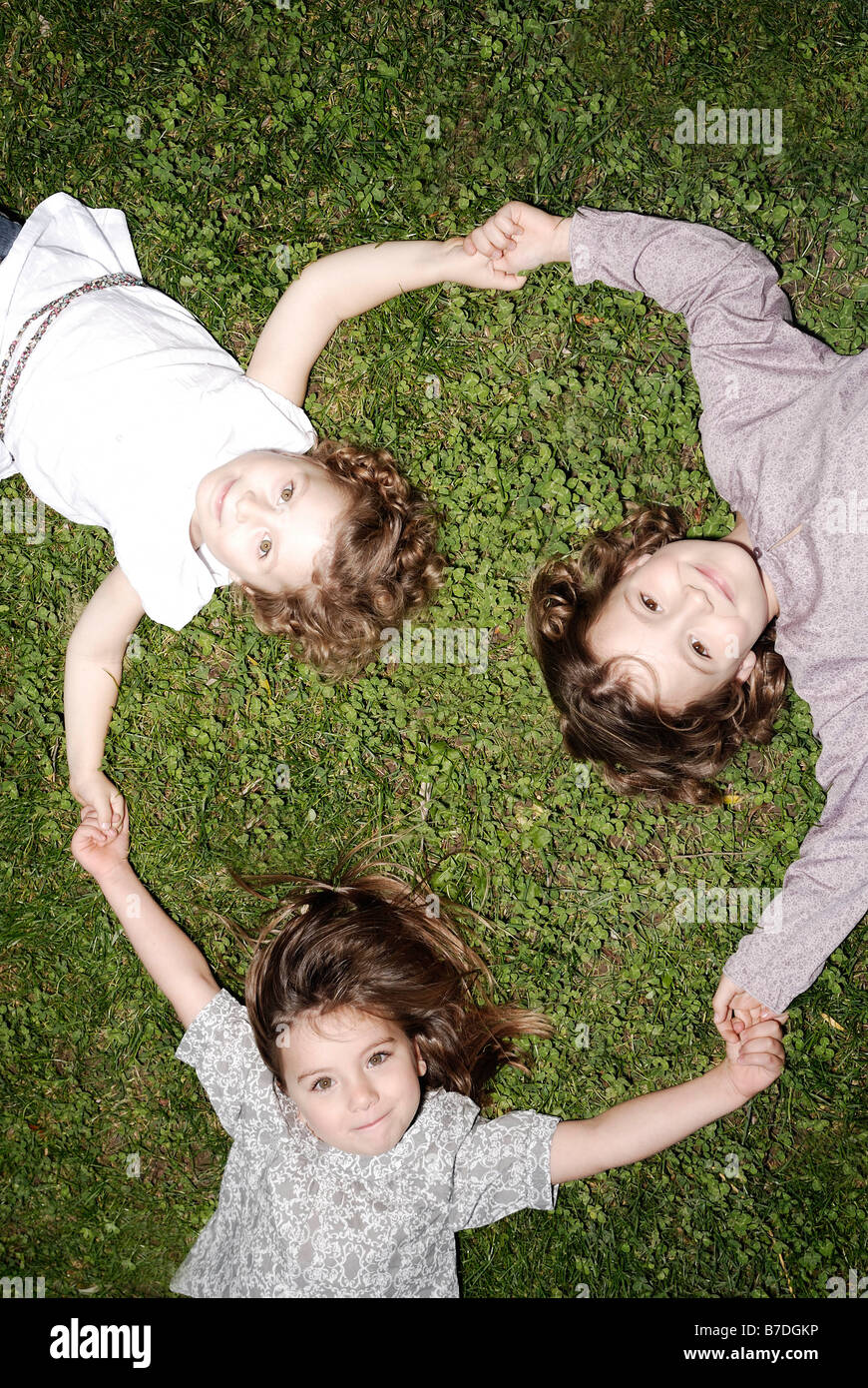 3 young girls holding hands Stock Photo - Alamy