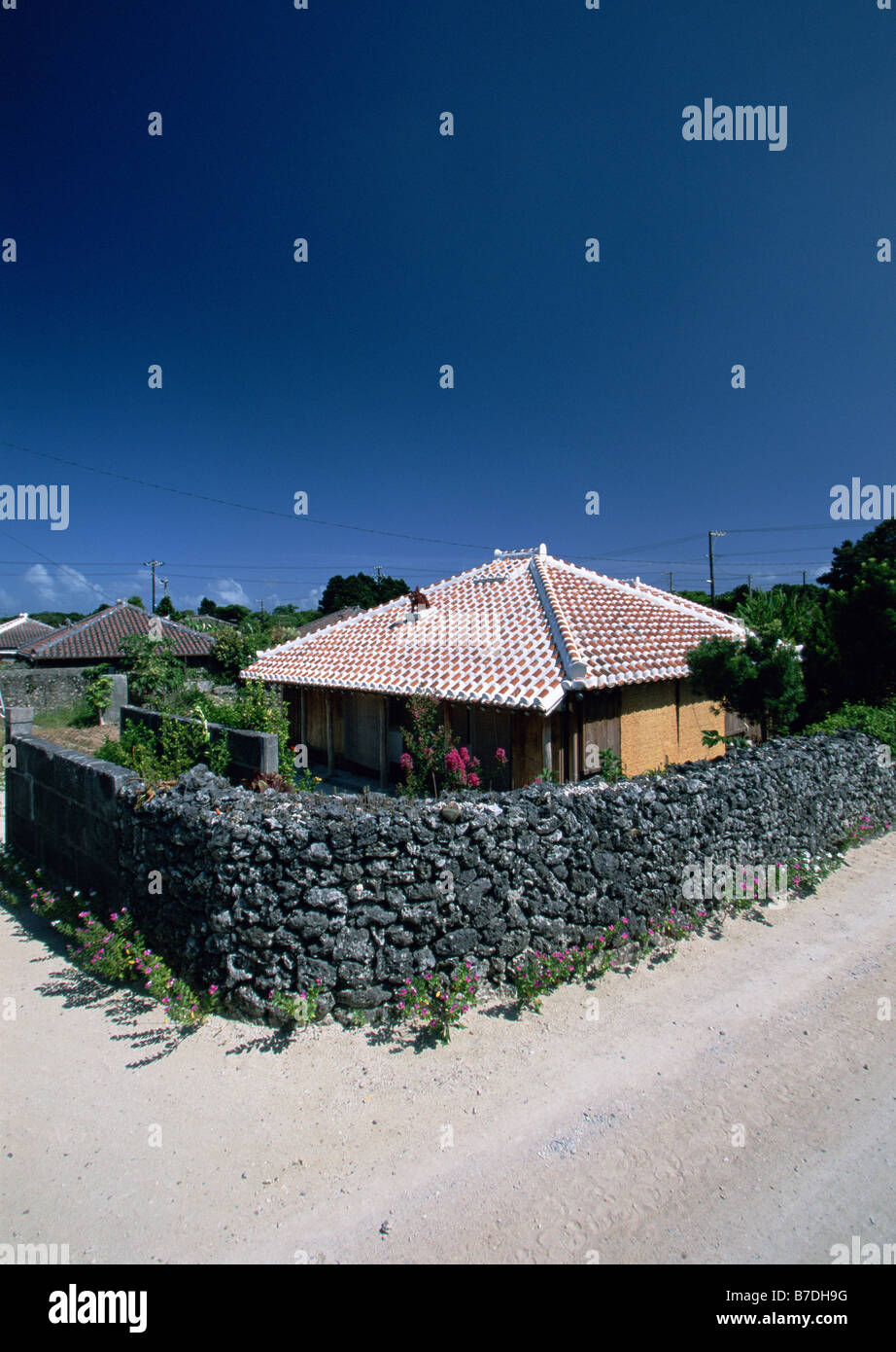 Stonewall and house Stock Photo Alamy