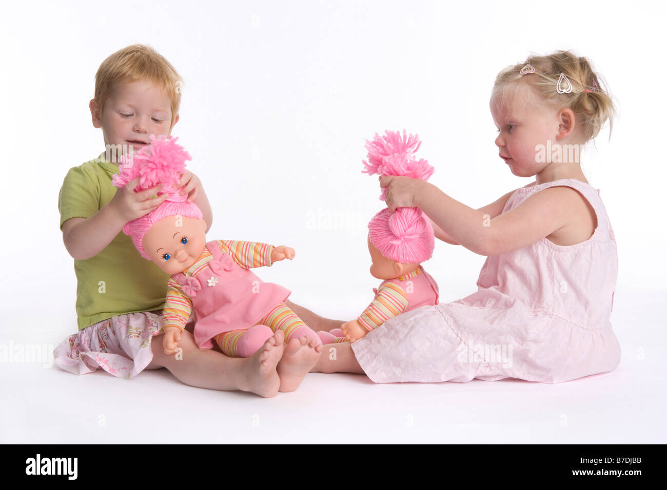 Two little girls playing with their dolls Stock Photo