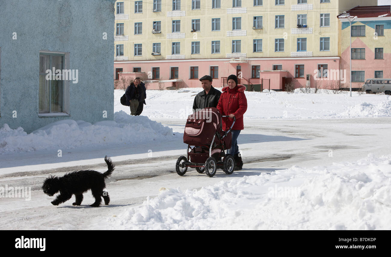 People walking with dog in Amguema, Chukotka, Siberia Russia Stock Photo