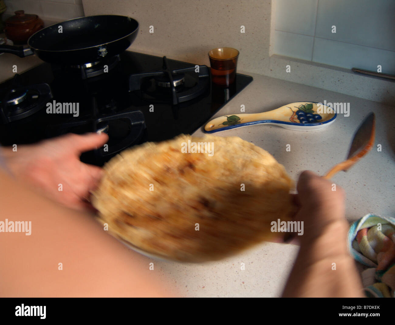 Woman serving, in a dish, a home made Spanish Tortilla (aka Tortilla de