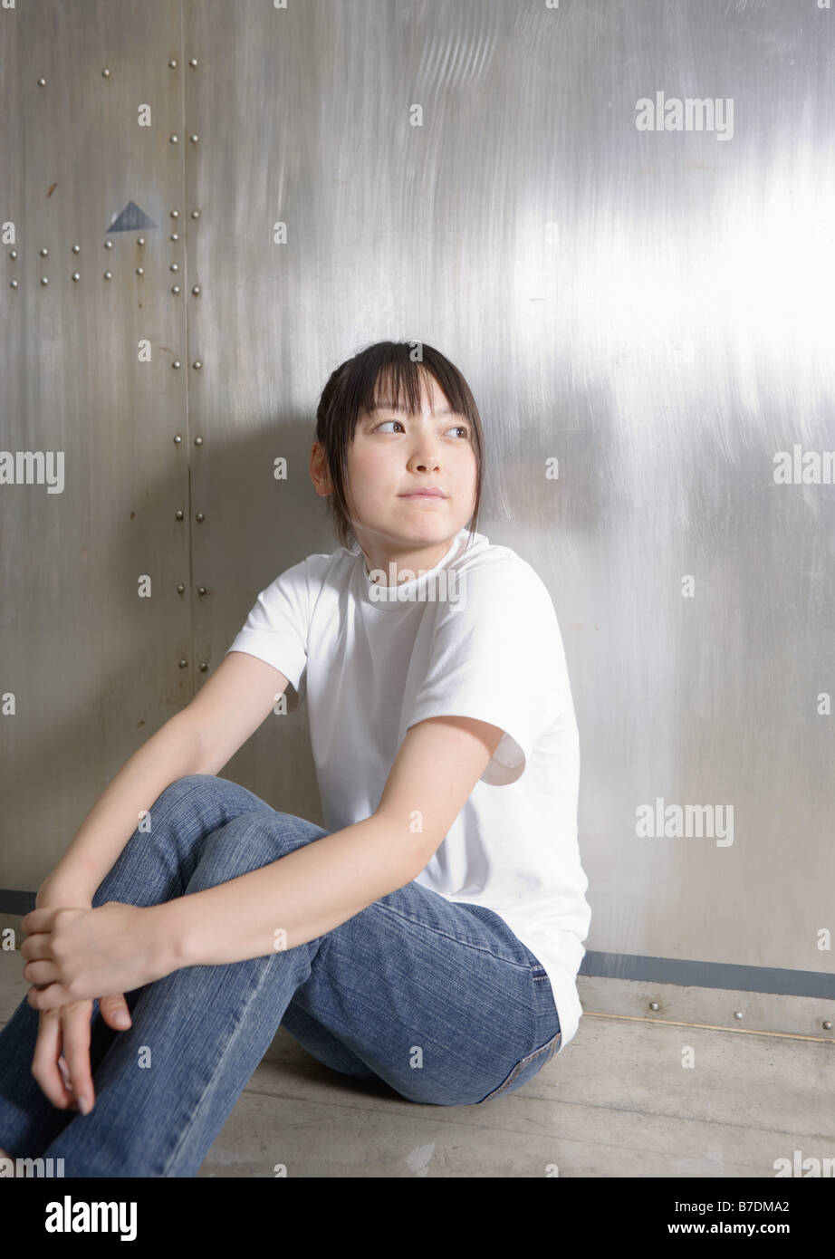 Back view woman sitting on wall hi-res stock photography and images - Alamy