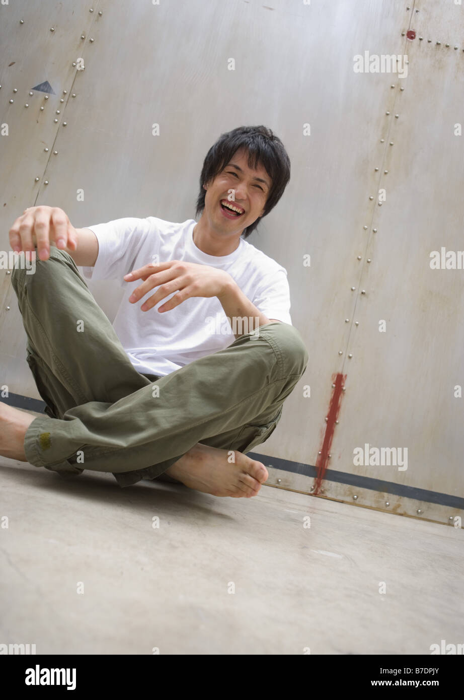 Man sitting cross-legged on floor Stock Photo - Alamy