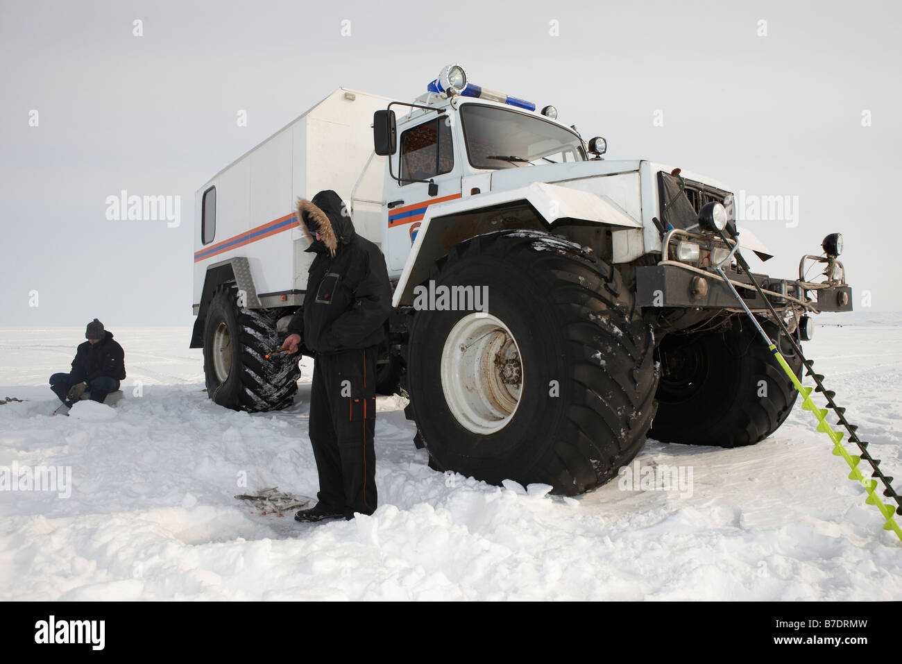 Ice fishing for smelts in front of modified truck,  Anadyr Chukotka, Siberia Russia Stock Photo