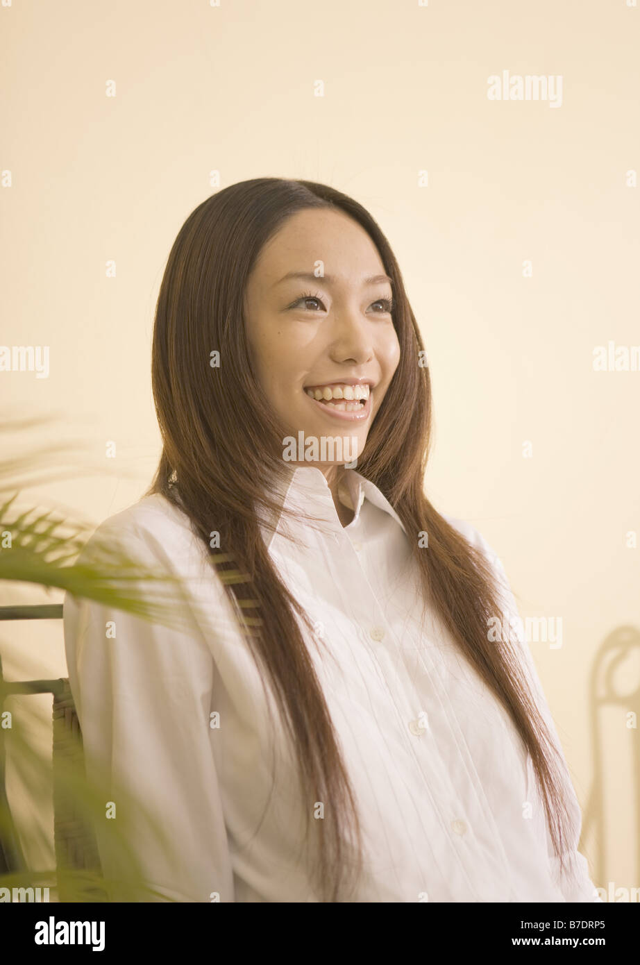 Woman with long hair in white shirt Stock Photo - Alamy