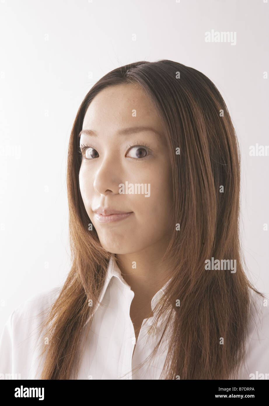Woman with long hair in white shirt Stock Photo - Alamy