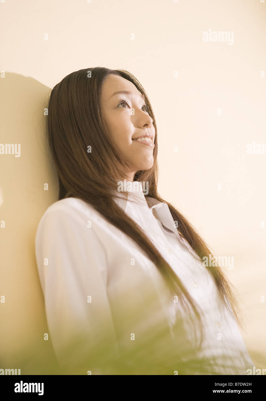Woman with long hair in white shirt Stock Photo - Alamy