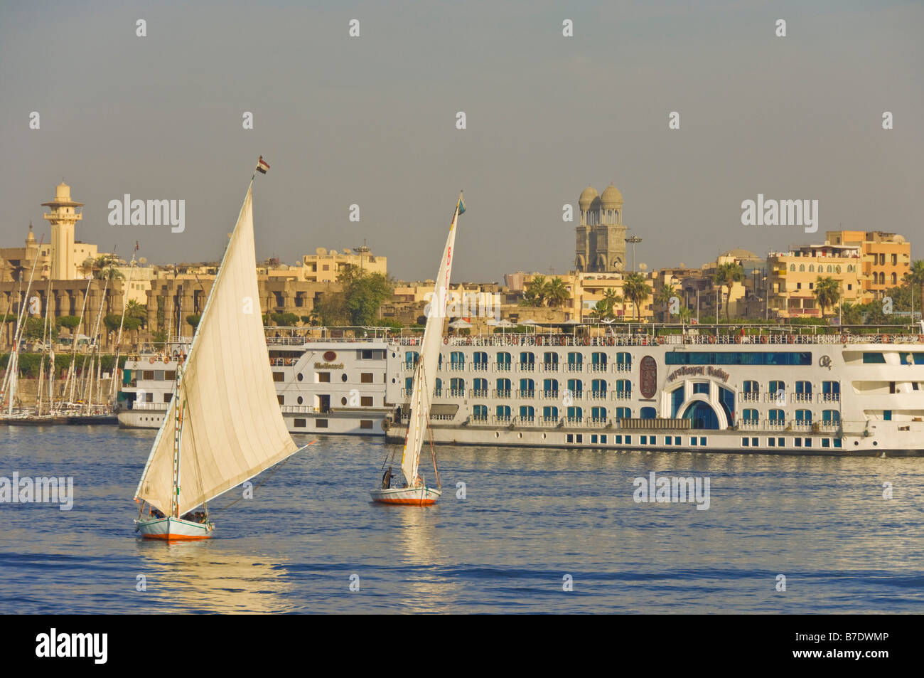 Traditional wooden sailing boats or Feluccas sailing on the river Nile ...