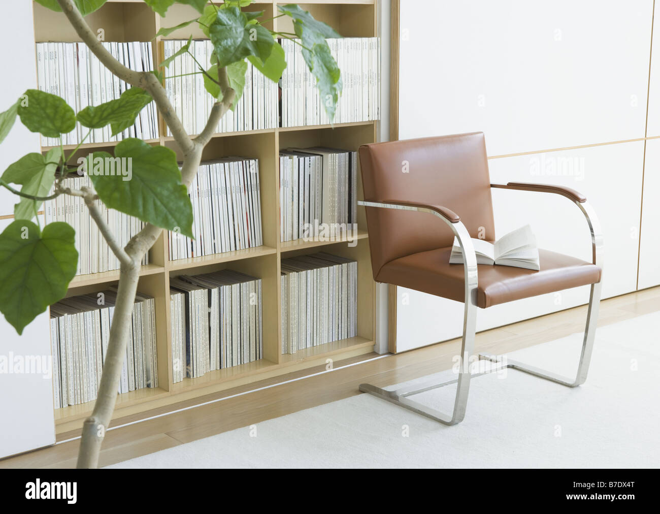 Bookshelf and chair Stock Photo - Alamy