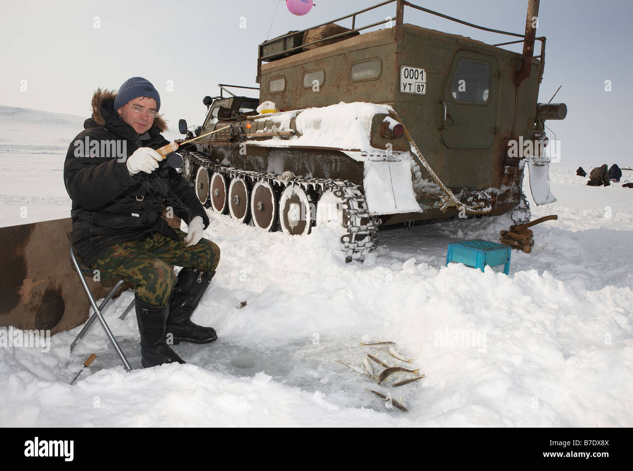 Ice fishing for smelts by modified tank (Vezdekhod) Anadyr Chukotka, Siberia Russia Stock Photo