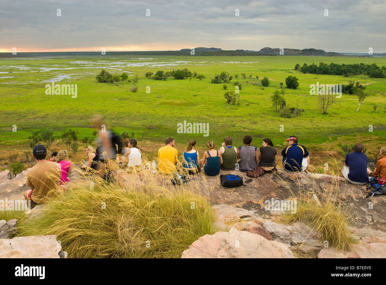 Tourists taking in a sunset from Ubirr overlooking the Nardab floodplain in Kakadu National Park Stock Photo