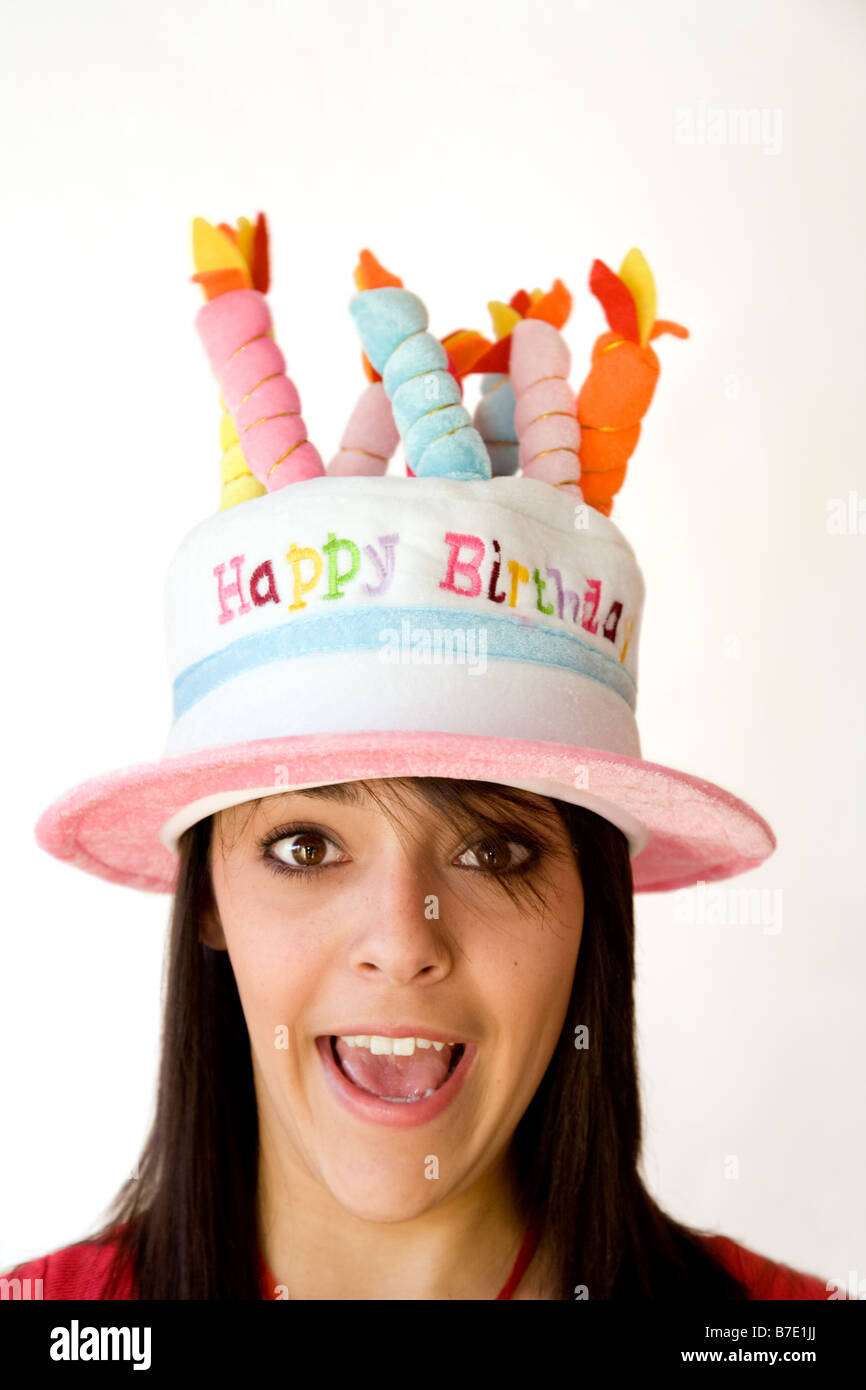 Happy teenage girl wearing "Happy Birthday" hat Stock Photo Alamy