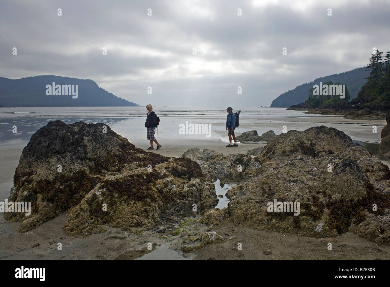 BRITISH COLUMBIA - Hikers exploring San Josef Bay on the northern tip of Vancouver Island in Cape Scott Provincial Park. Stock Photo