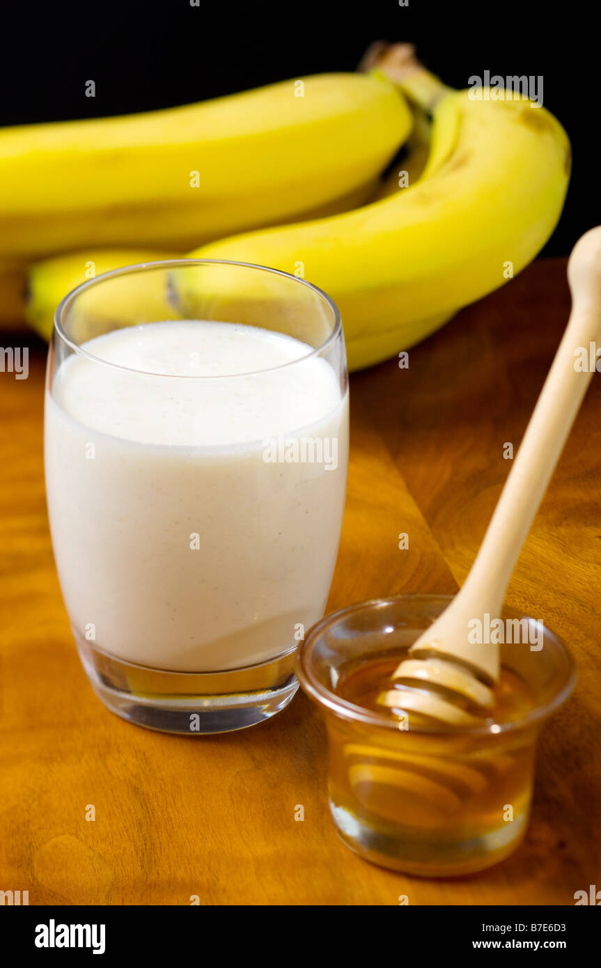 Glass of milk banana and honey Stock Photo - Alamy
