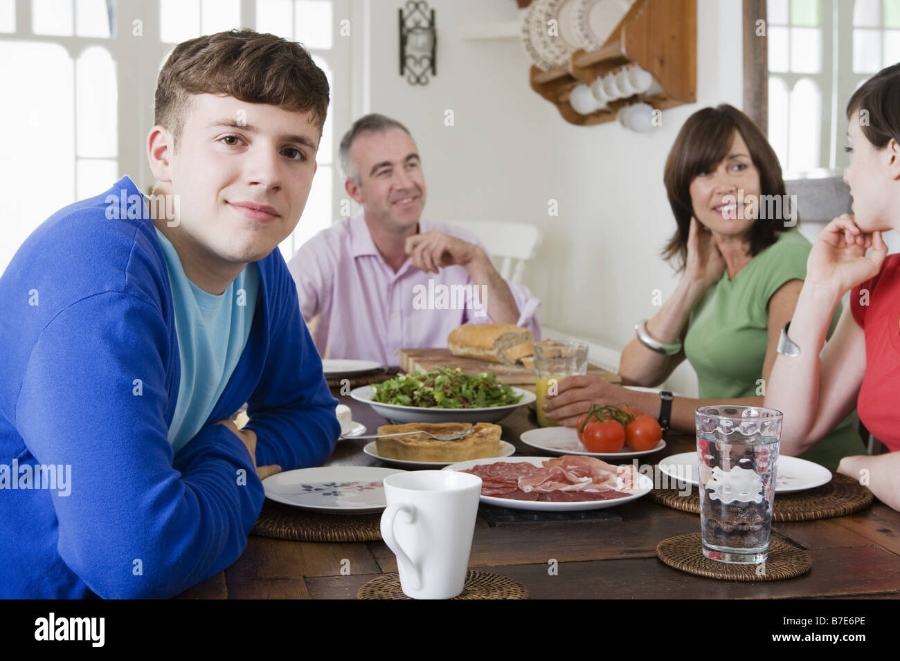 A family sat at a dining table Stock Photo
