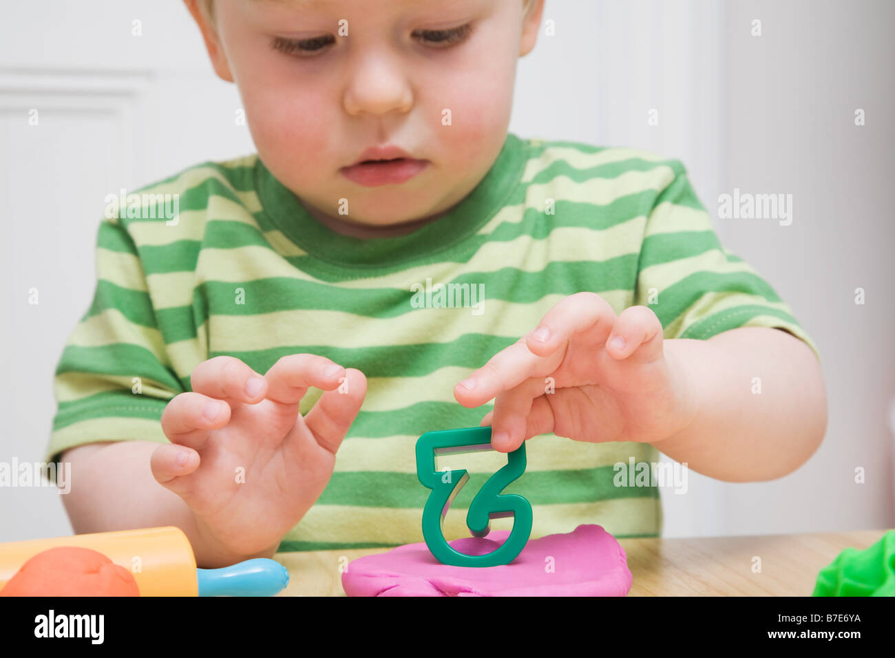 Little boy with modelling clay Stock Photo