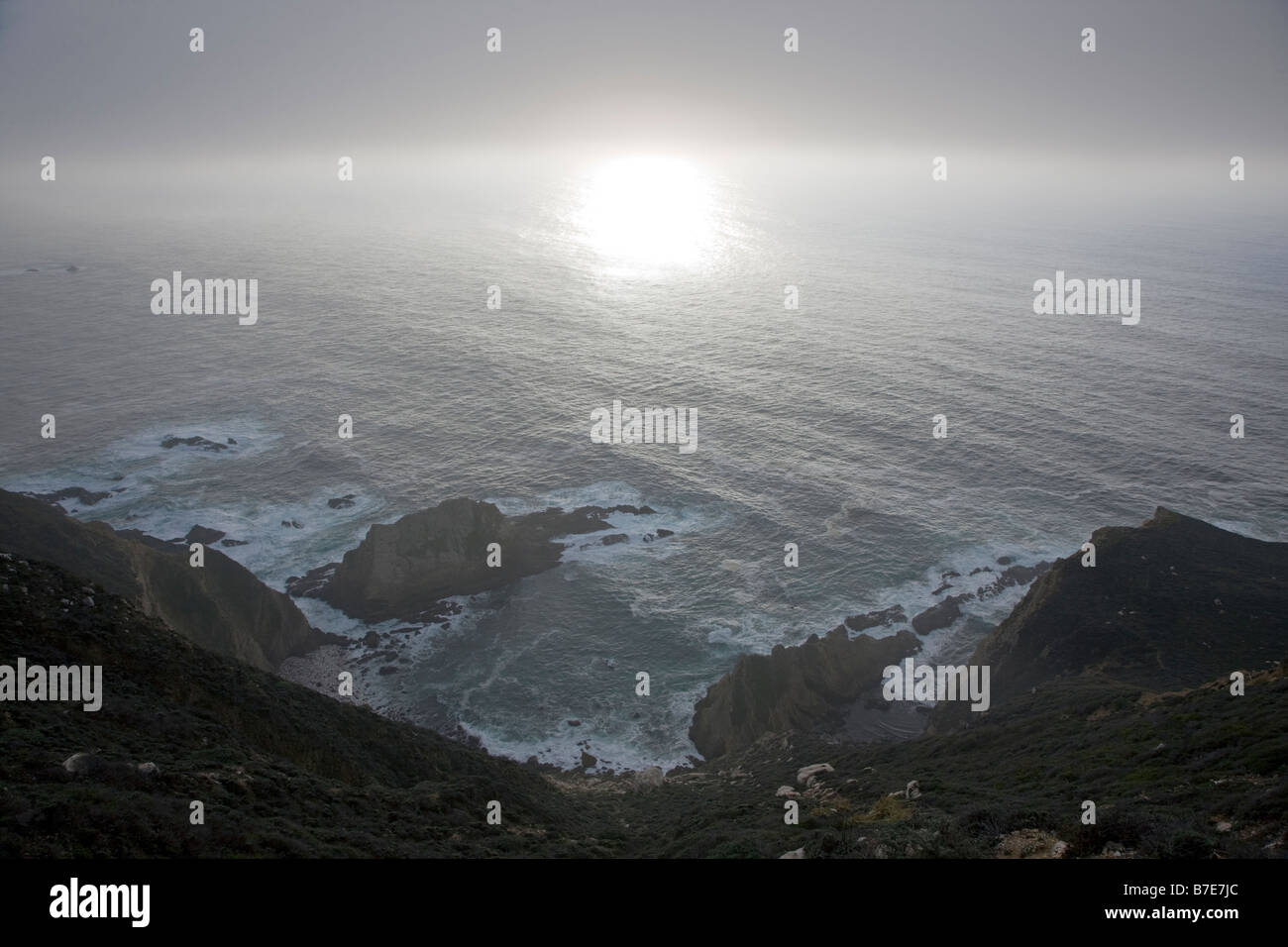 Reflection of the sun in the Pacific Ocean viewed from Highway 1, Big Sur, California, USA Stock Photo