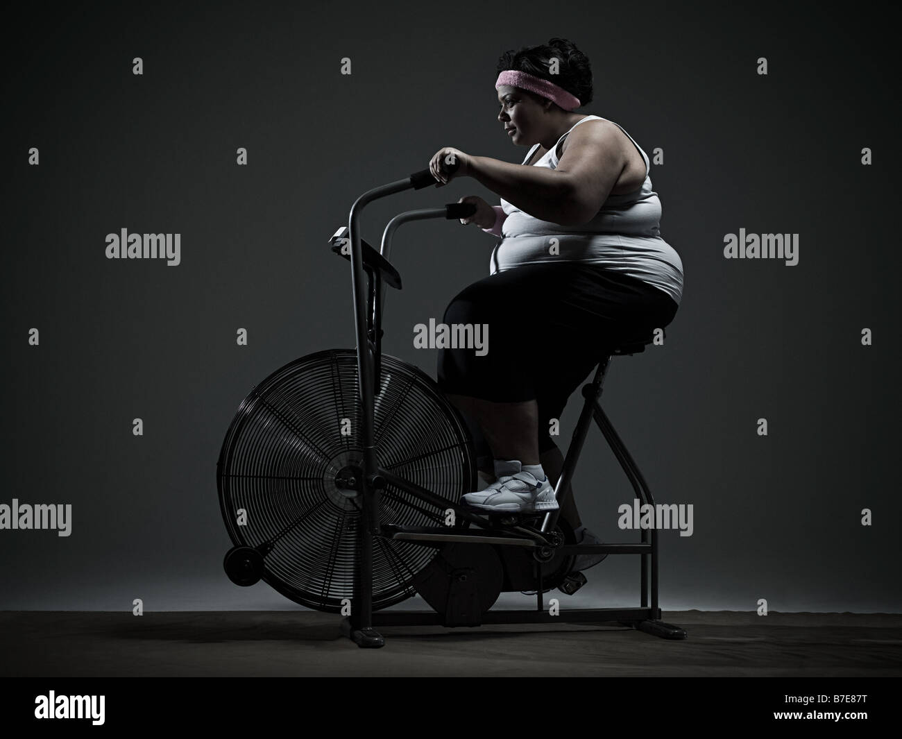 Overweight woman on exercise bike hi res stock photography and images Alamy