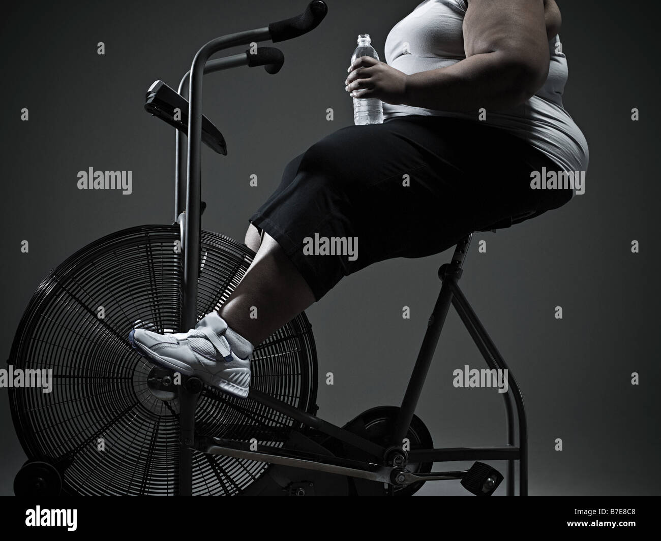 Woman overweight exercise bike hires stock photography and images Alamy