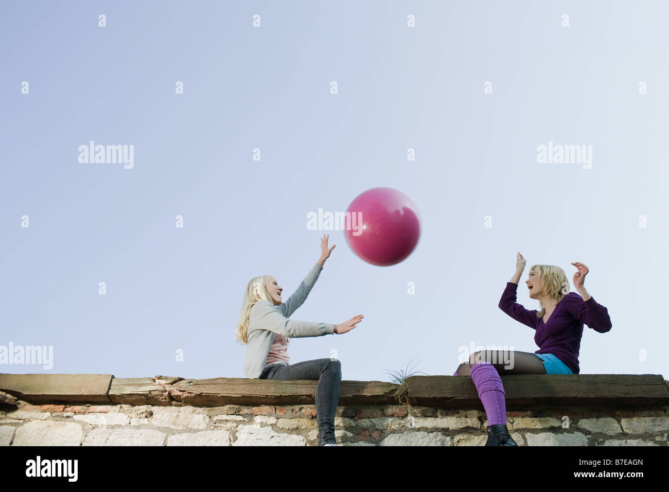 Friends throwing a ball Stock Photo Alamy