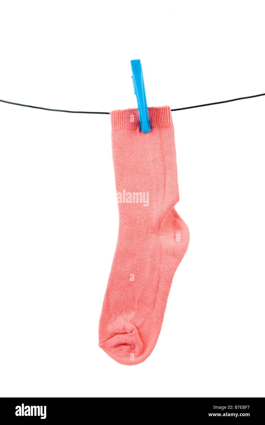 A pink sock on a line with a blue peg Stock Photo