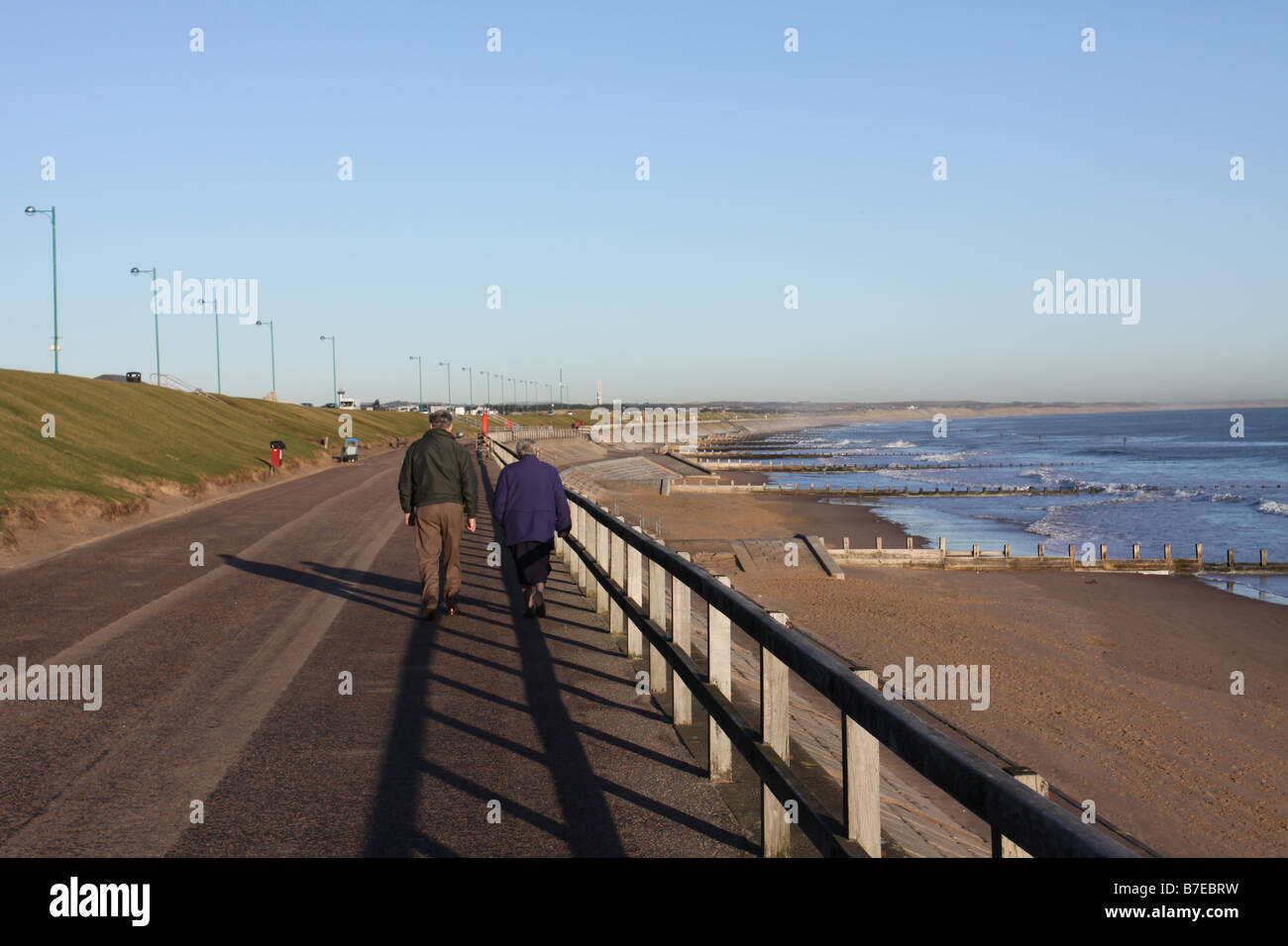 Couple walking beside Aberdeen beach Scotland January 2009 Stock Photo