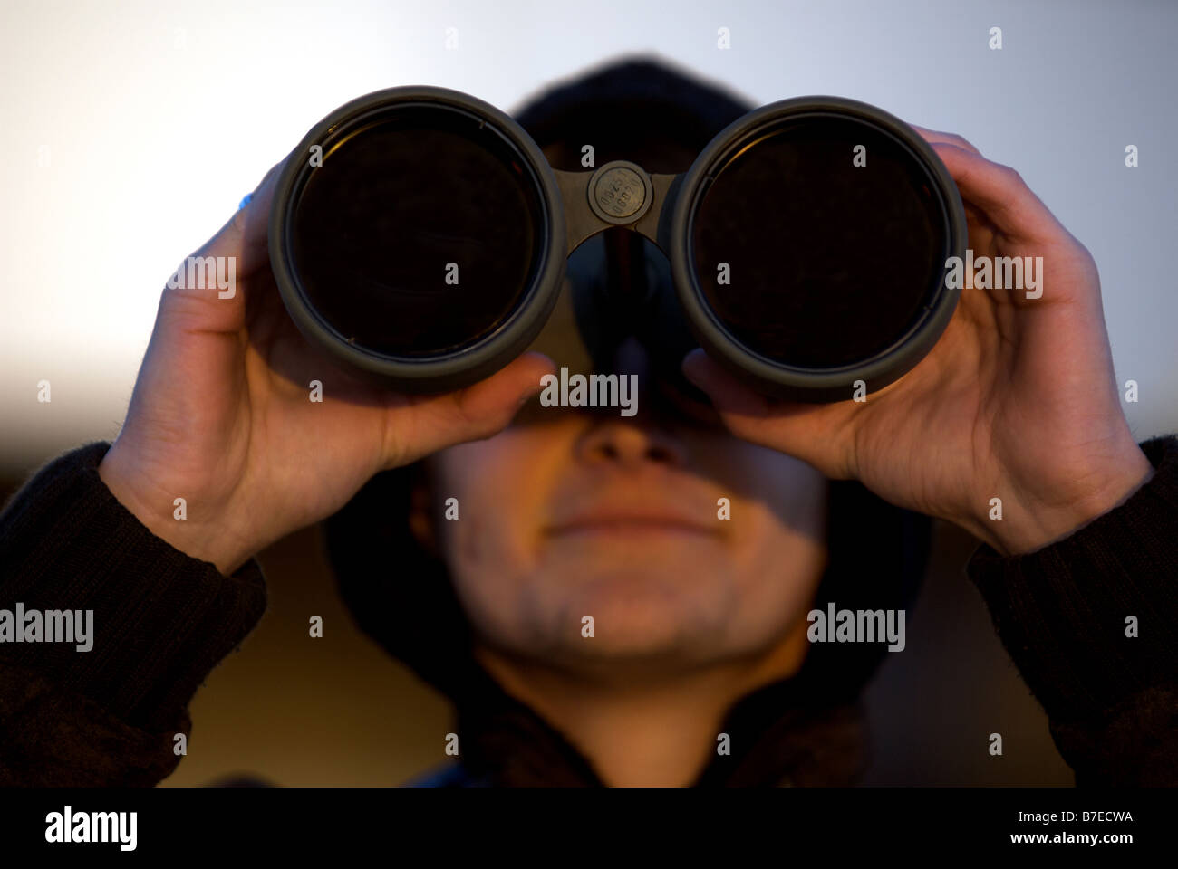 Plane spotter using powerful binoculars to watch aircraft at Dusseldorf