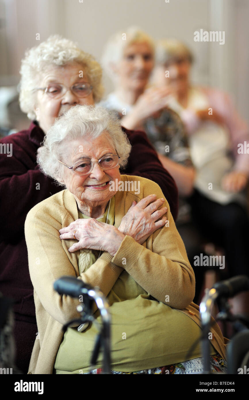 Elderly people participate in chair exercises during a health promotion day run by the Bradford Council Ilkley West Yorkshire Stock Photo