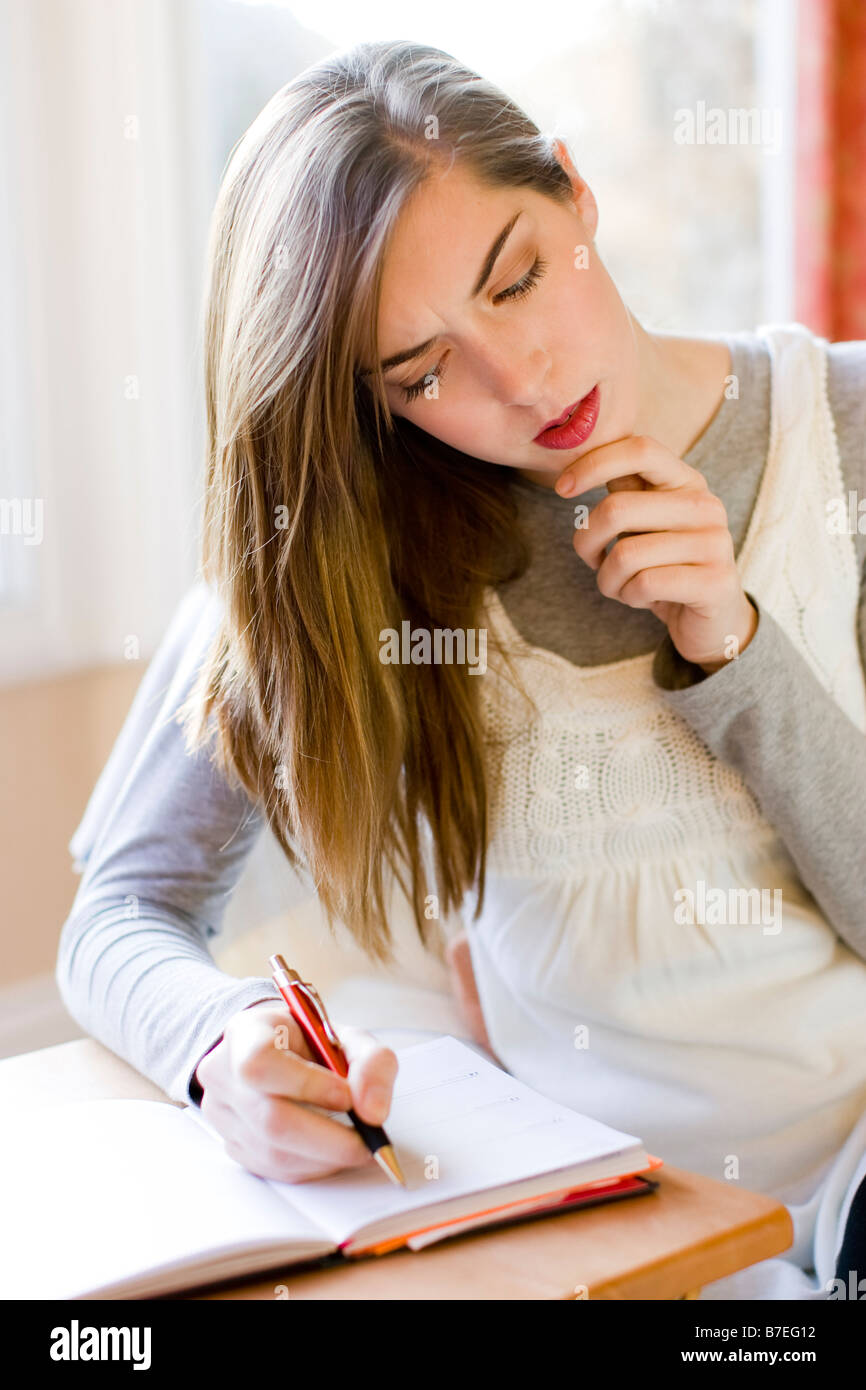 Girl writing in diary Stock Photo