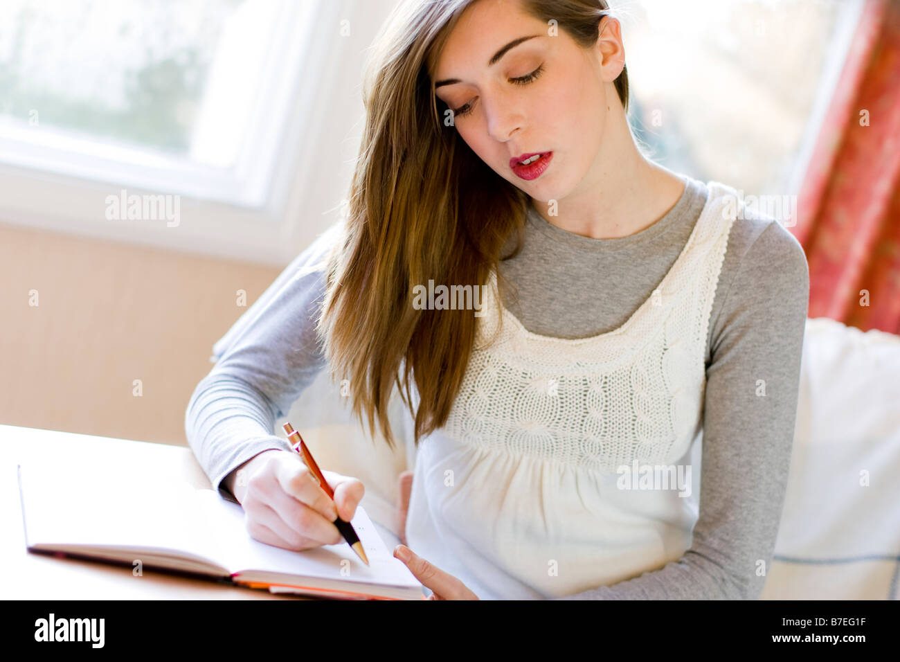 Girl writing in diary Stock Photo