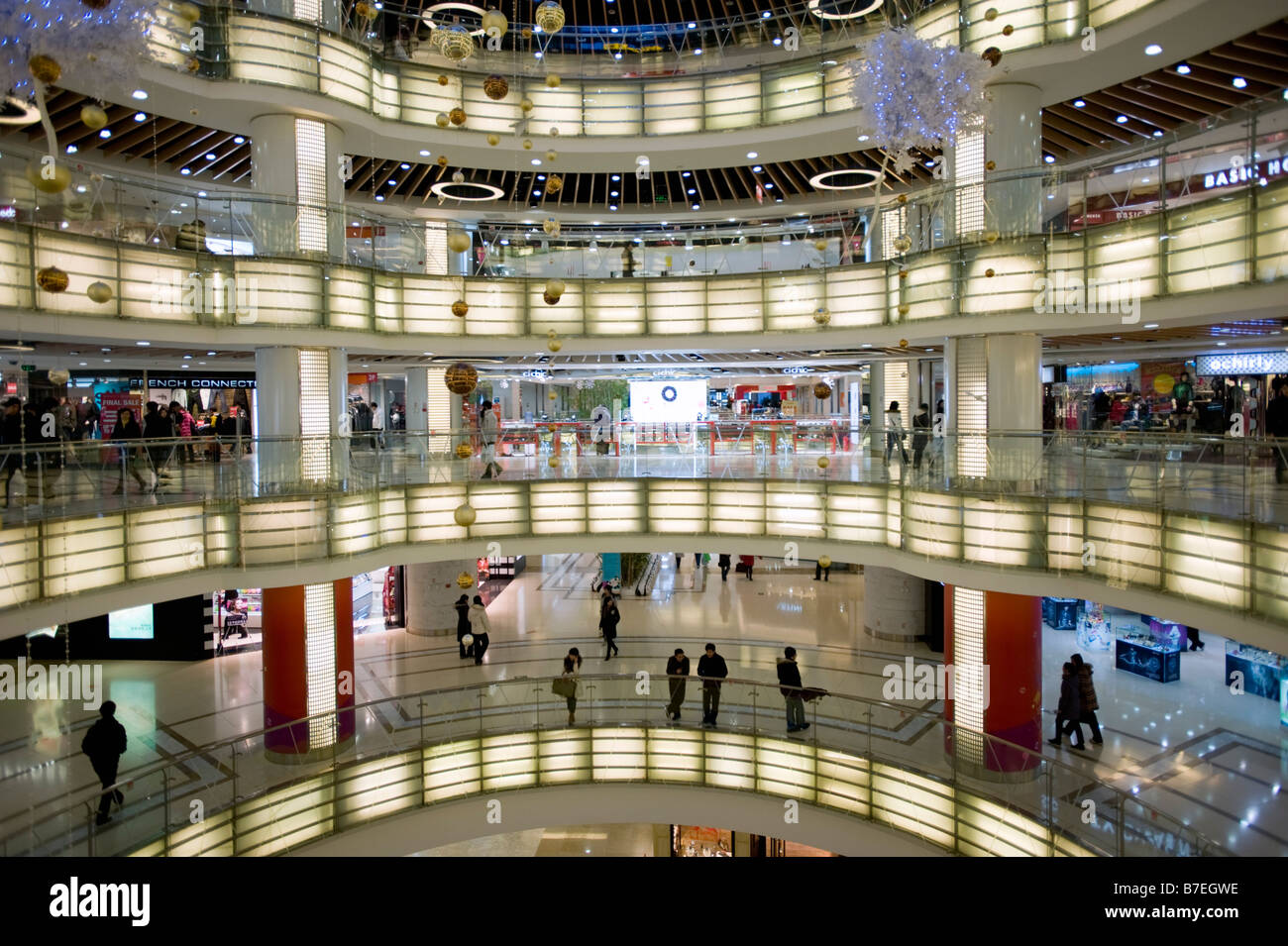 Interior of large new modern shopping mall called Joy City in Xidan district Beijing 2009 Stock Photo