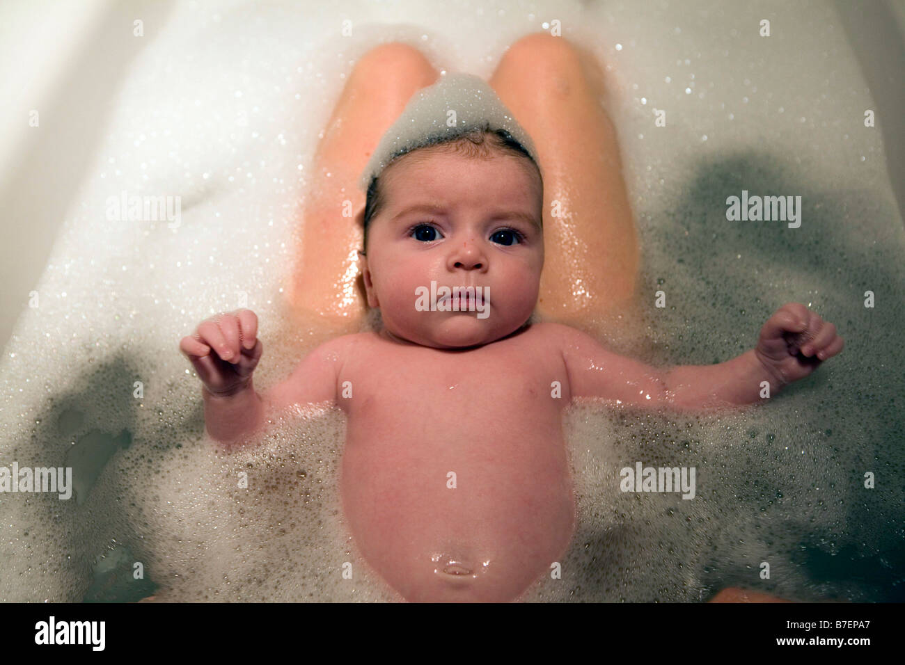 baby girl having a bath with foam on her head Stock Photo Alamy