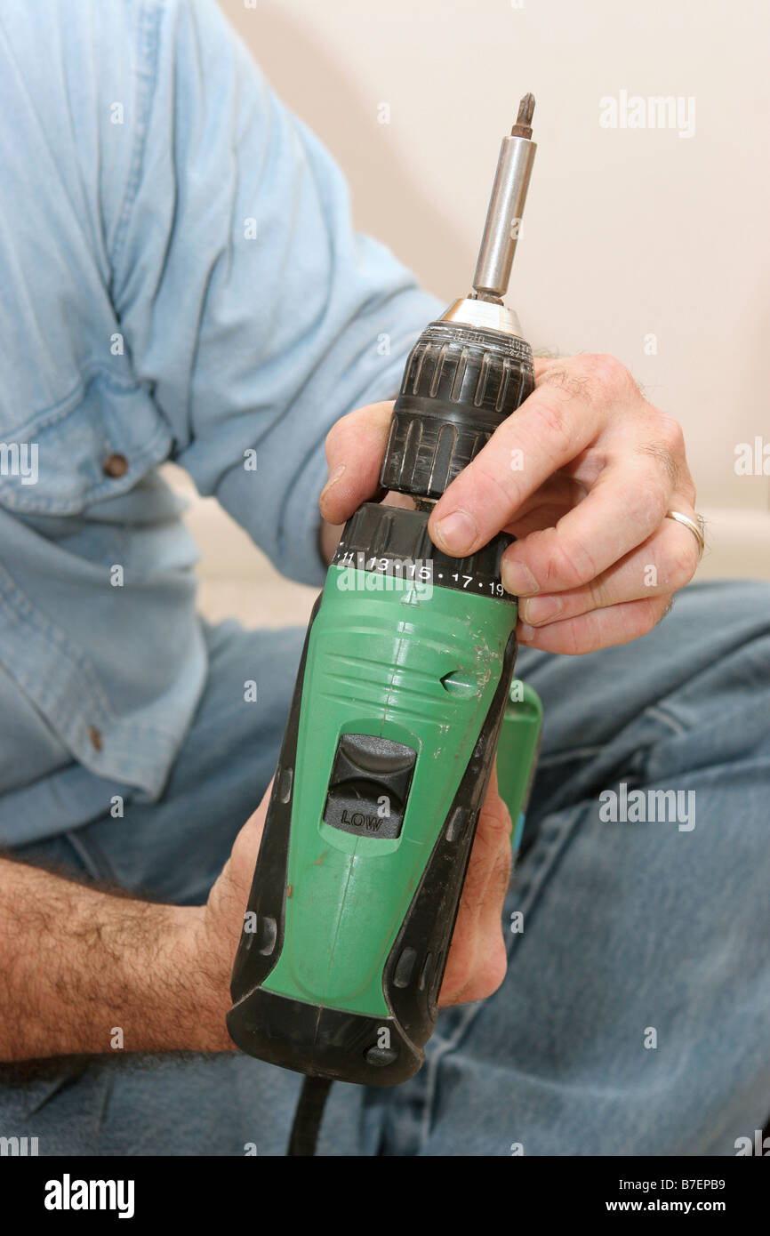 A workman setting the proper torque on his drill Stock Photo Alamy