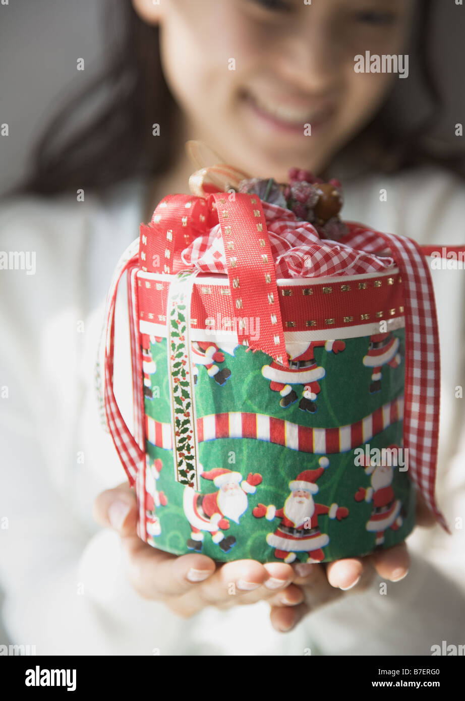 A woman giving Christmas present Stock Photo - Alamy
