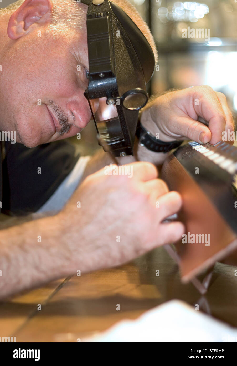 a craftsman building a replica of a battle ship focus is on his face Stock Photo