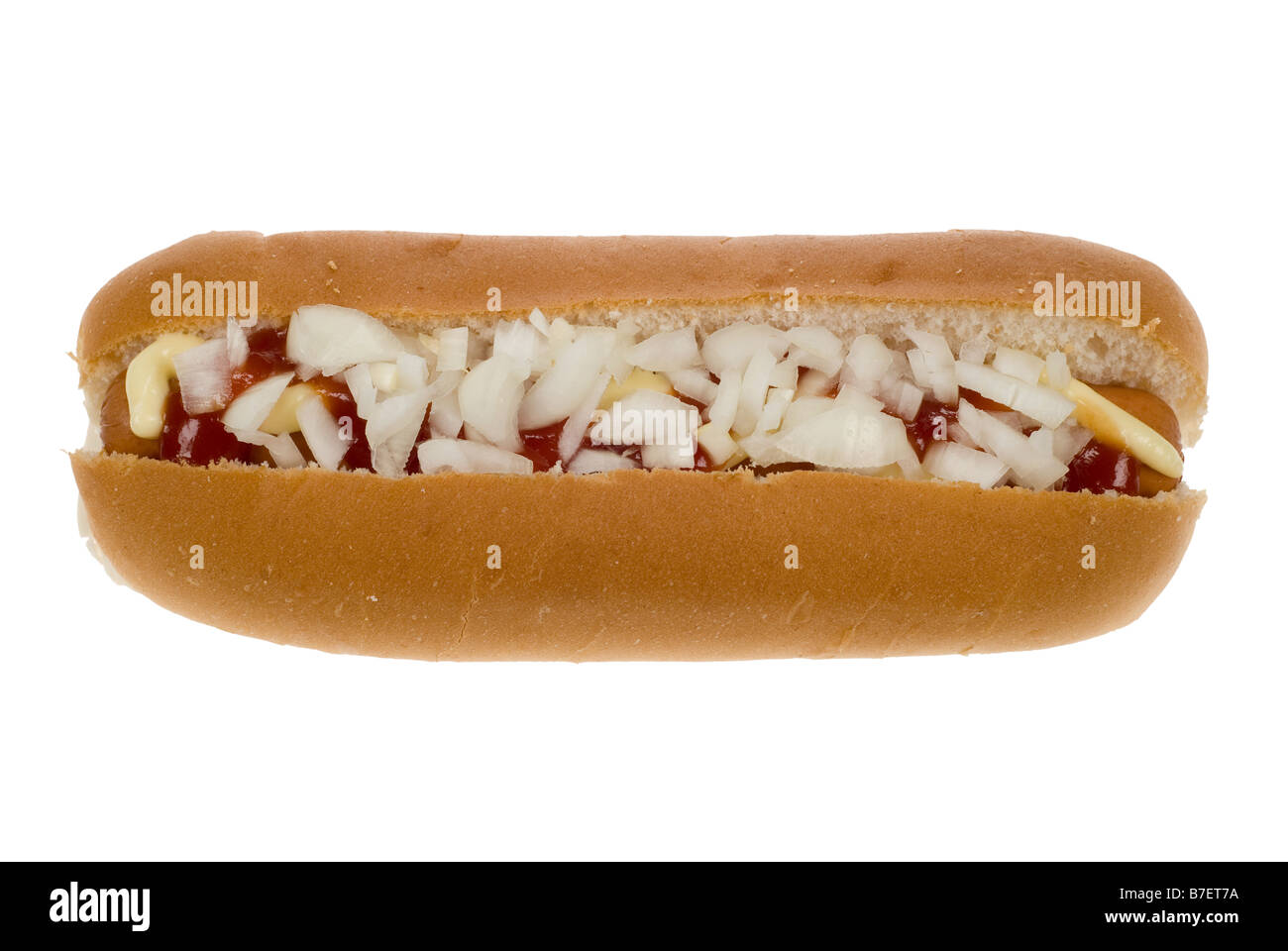 hot dog in a bun with mayonaise ketchup and onion isolated on a white