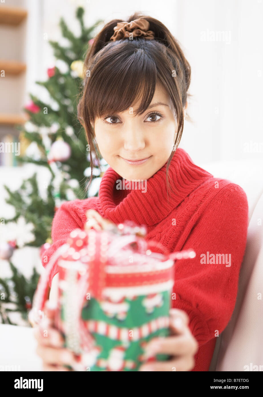 A woman giving Christmas present Stock Photo - Alamy