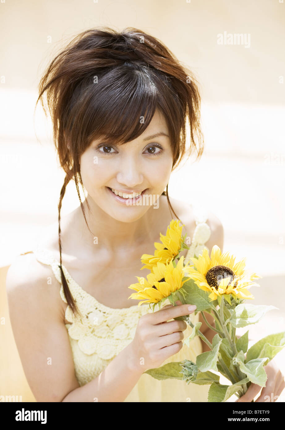 A woman holding sunflowers Stock Photo - Alamy