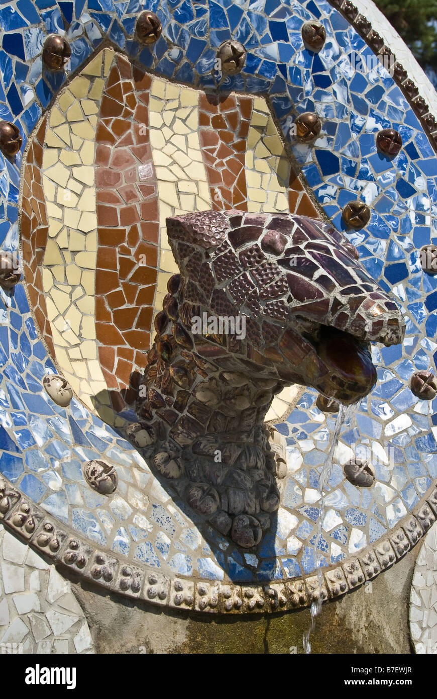 a head of a saurian made of tiles and stones styled by antonio gaudie in park guell Stock Photo