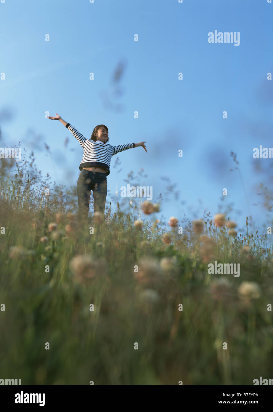 Woman stretching in field Stock Photo