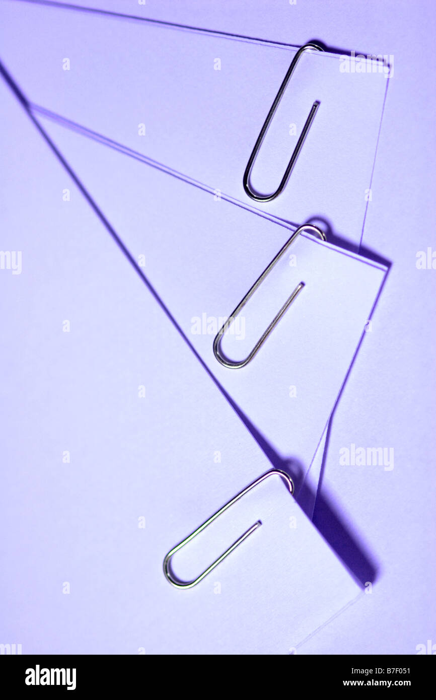 Paperclip on paper in pile close up Stock Photo Alamy