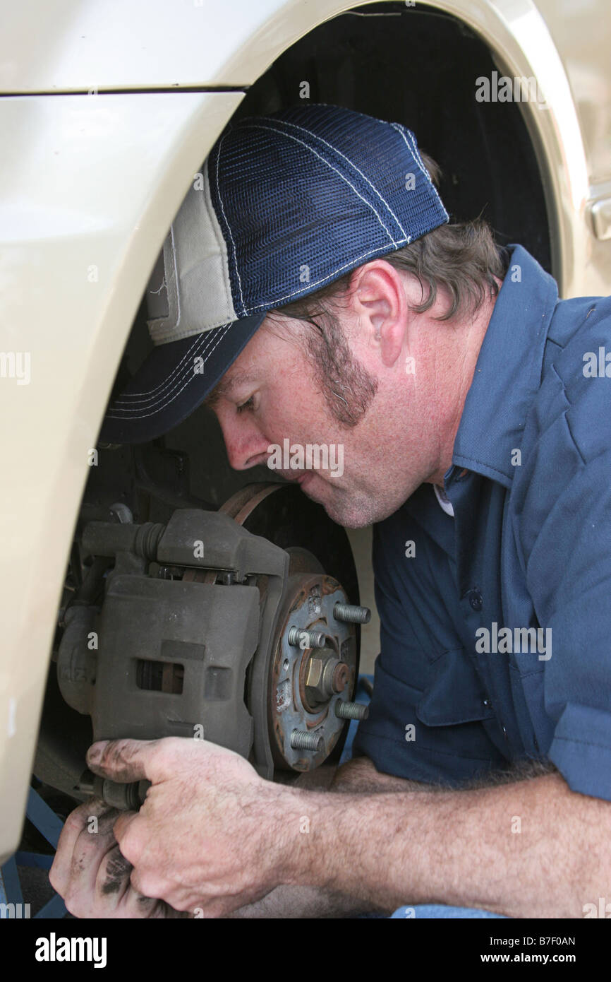 A closeup of an auto mechanic concentrating as he fixes a car Stock Photo -  Alamy