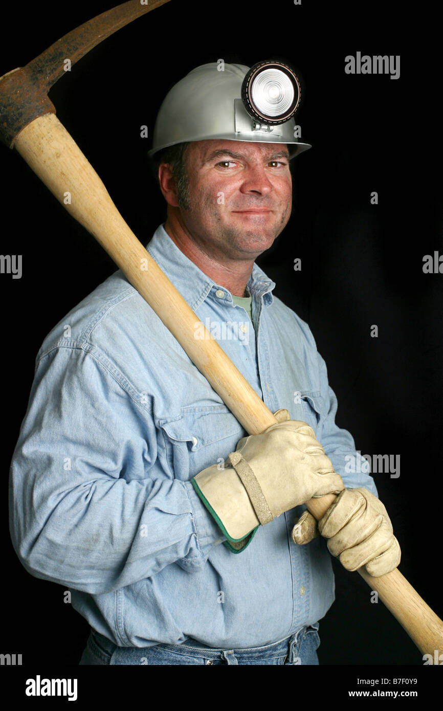 A friendly coal miner with his pick ax over his shoulder Stock Photo