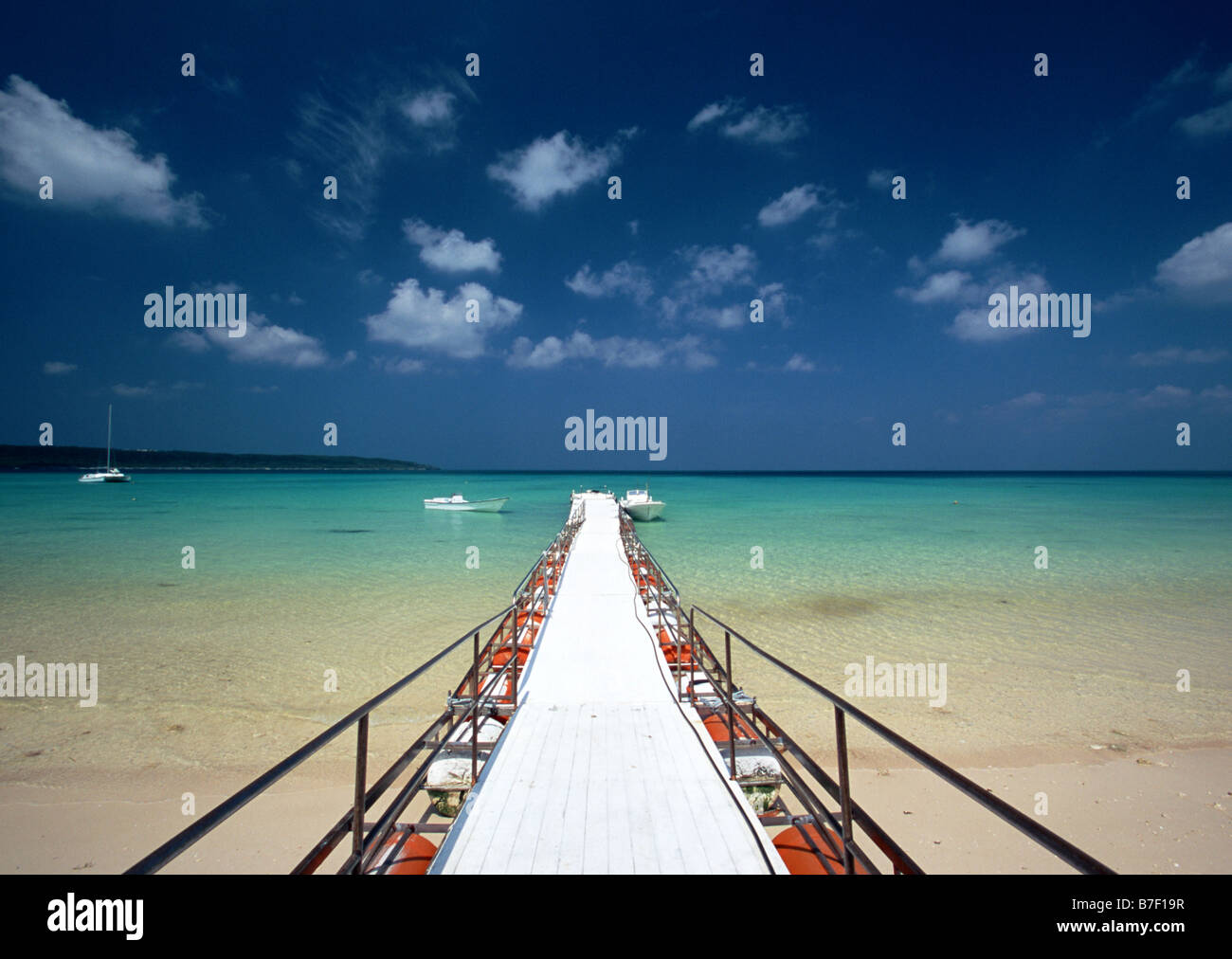 Pier and shallow beach Stock Photo