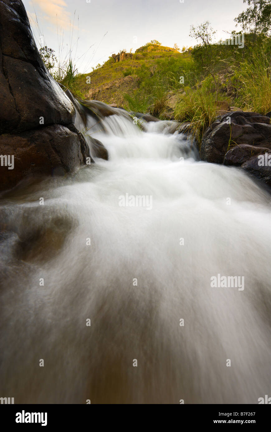 Water gently flowing over rocks from Maguk Falls in Kakadu National Park Stock Photo