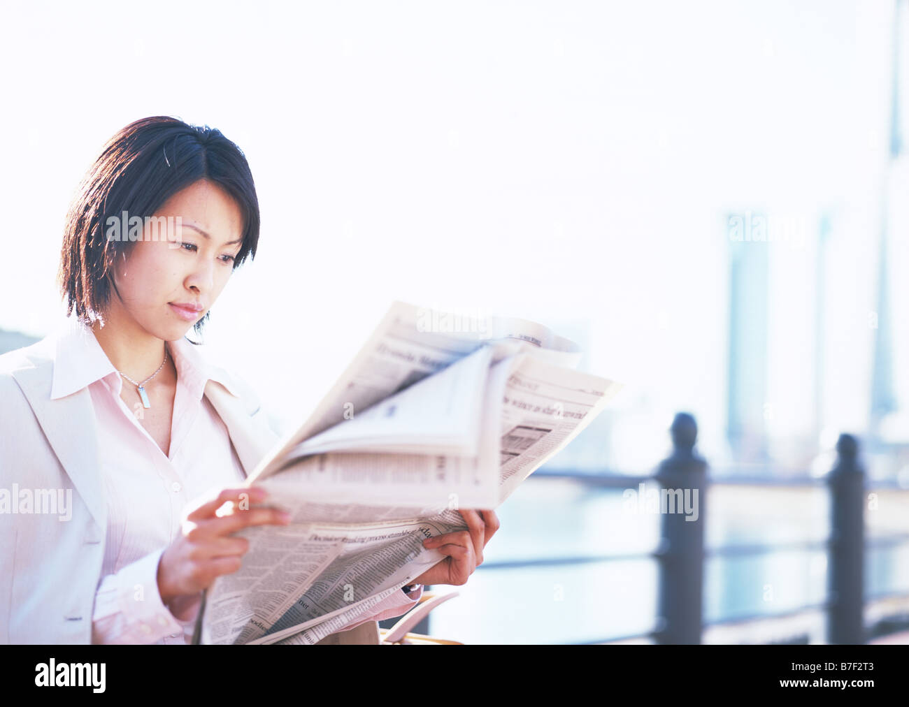 Business woman reading newspaper Stock Photo - Alamy