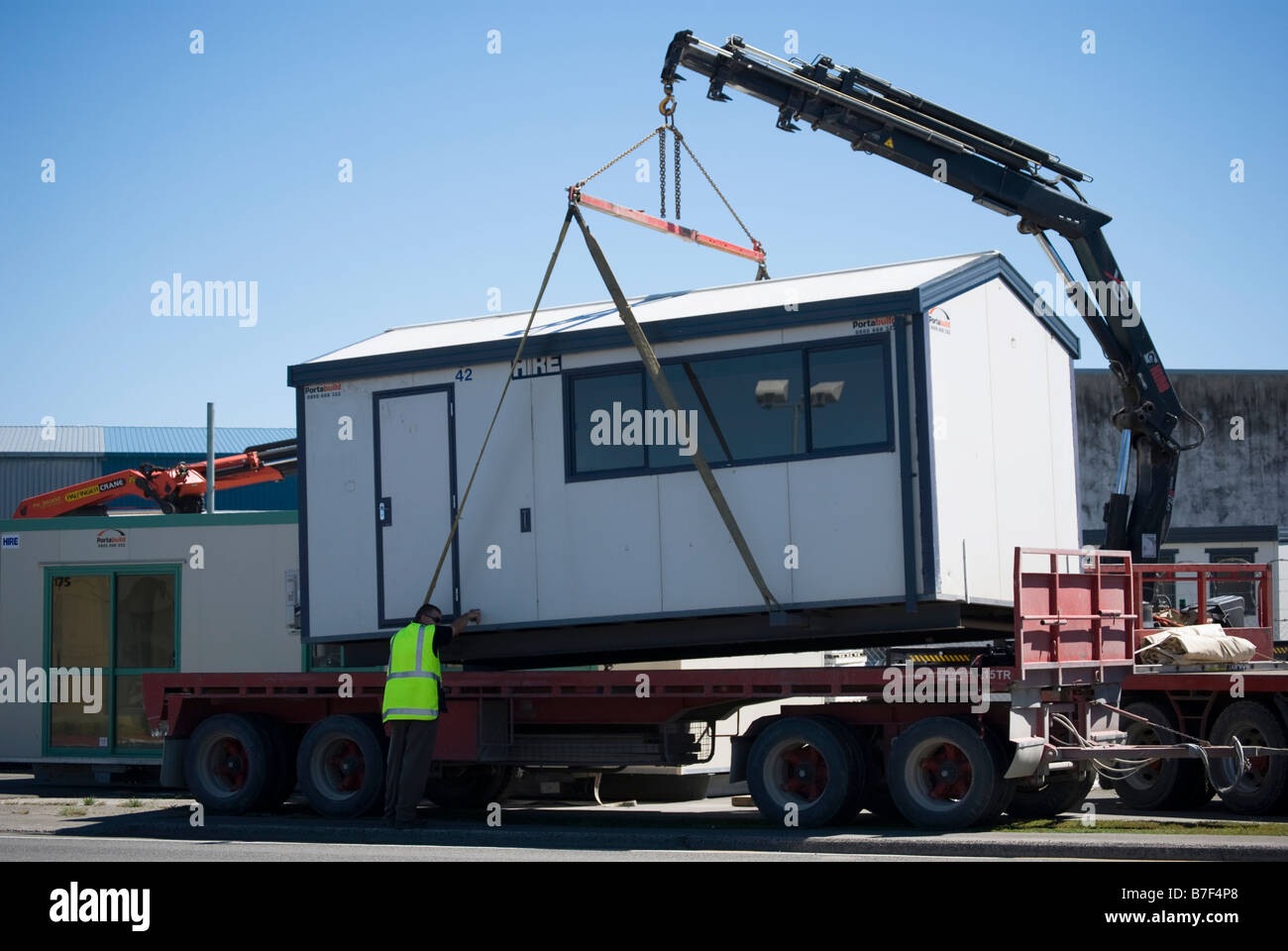 Portable Building being laded on truck, Blenheim Road, Sockburn, Christchurch, Canterbury, New Zealand Stock Photo