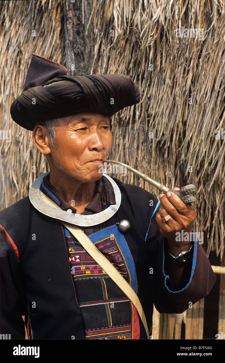 Portrait of Akha Man from northern Thai Hill tribe Smoking Opium Pipe, near Chiang Rai, northern Thailand Stock Photo